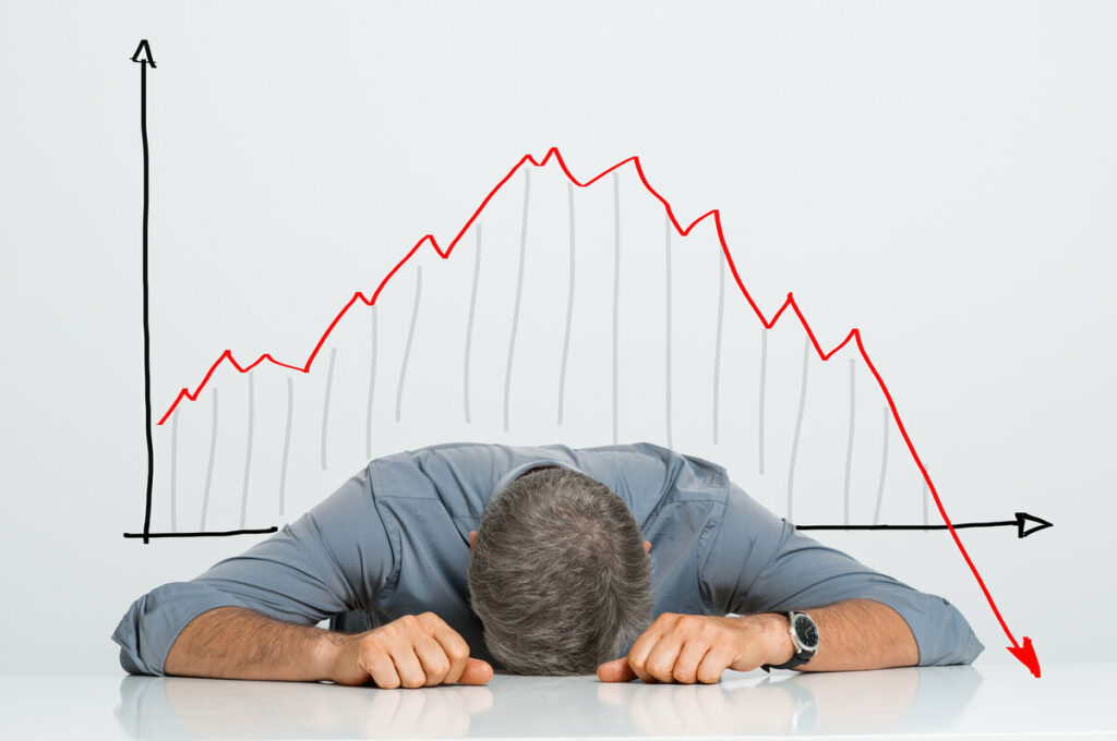 stock market graph behind man